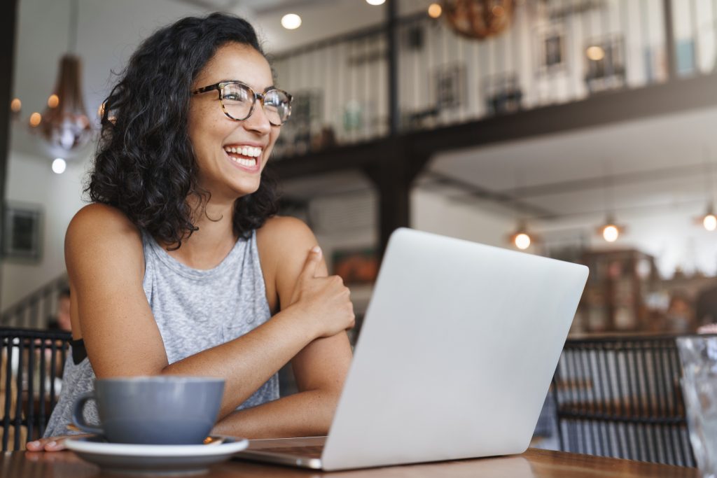 woman working on computer at a coffee shop